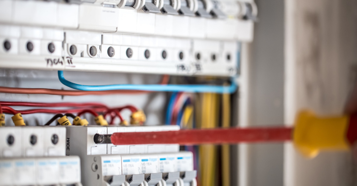 Electrical Technician Working On Switchboard