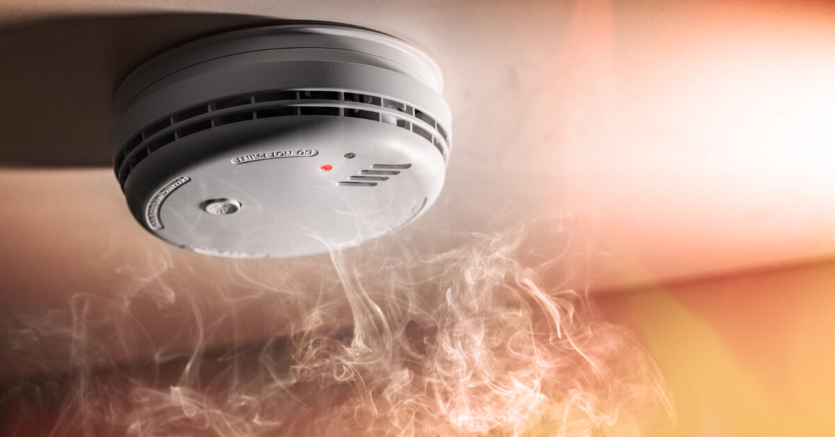 Smoke Detector And Interlinked Fire Alarm In Action Background